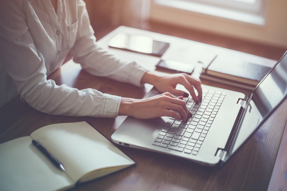 woman typing on laptop