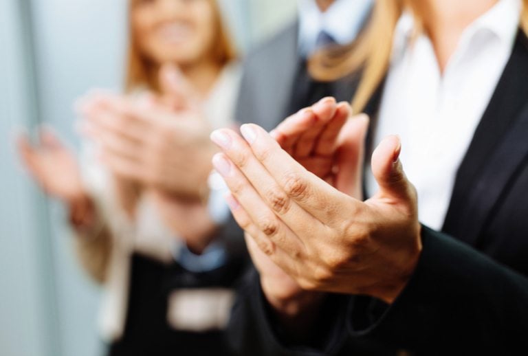 two women clapping their hands