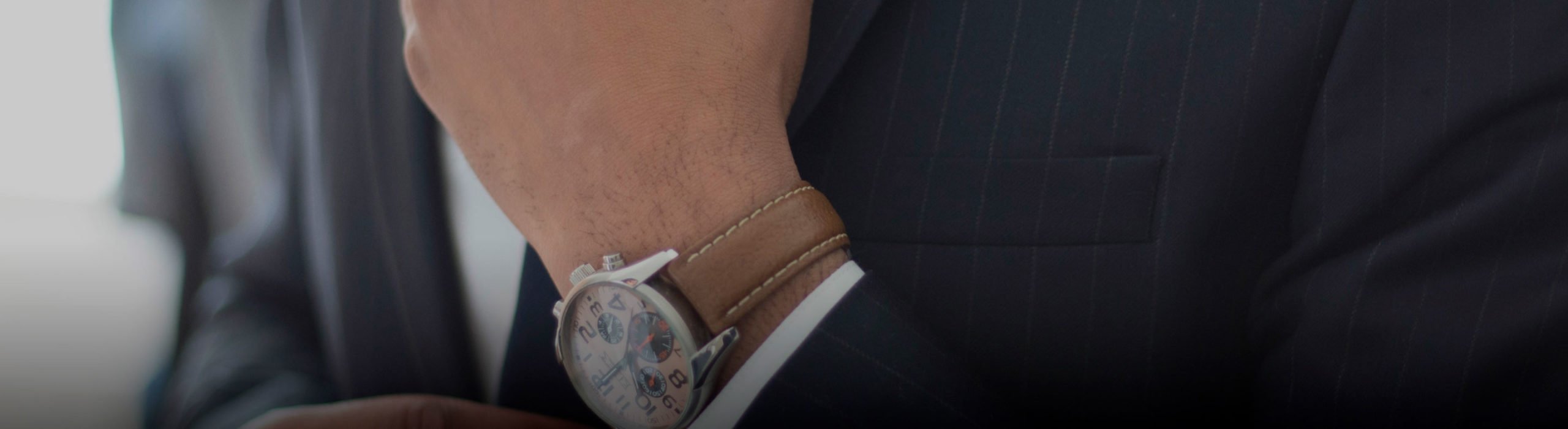 close up of a watch on a mans wrist