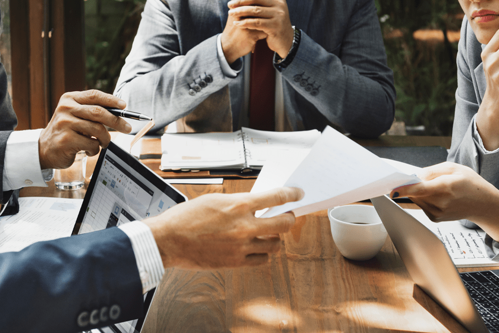 group of business workers going over information at meeting