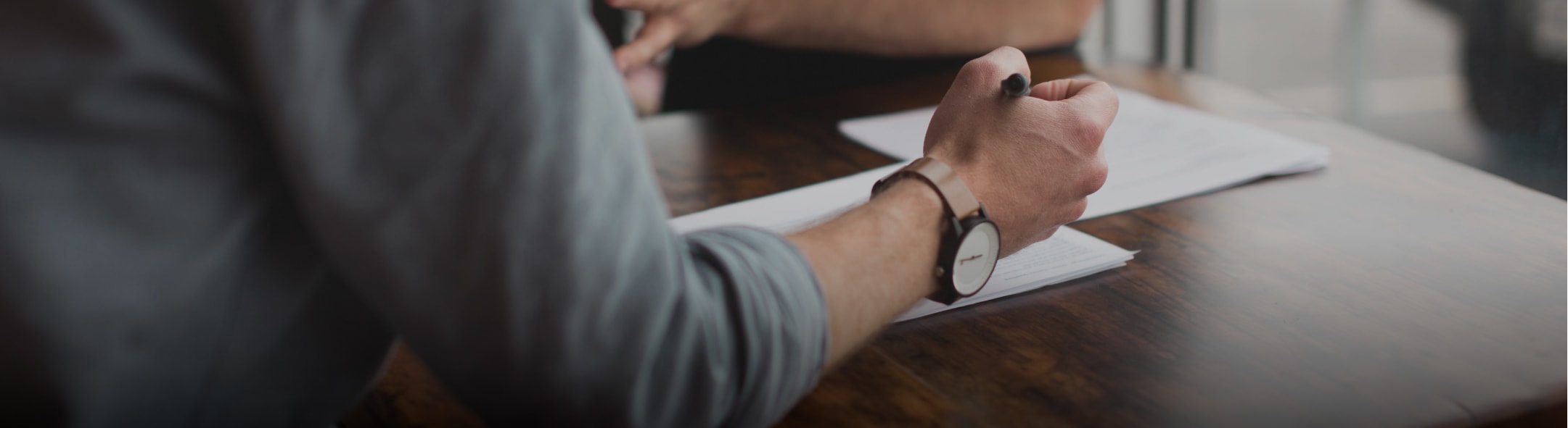 close up of gentleman holding a pen