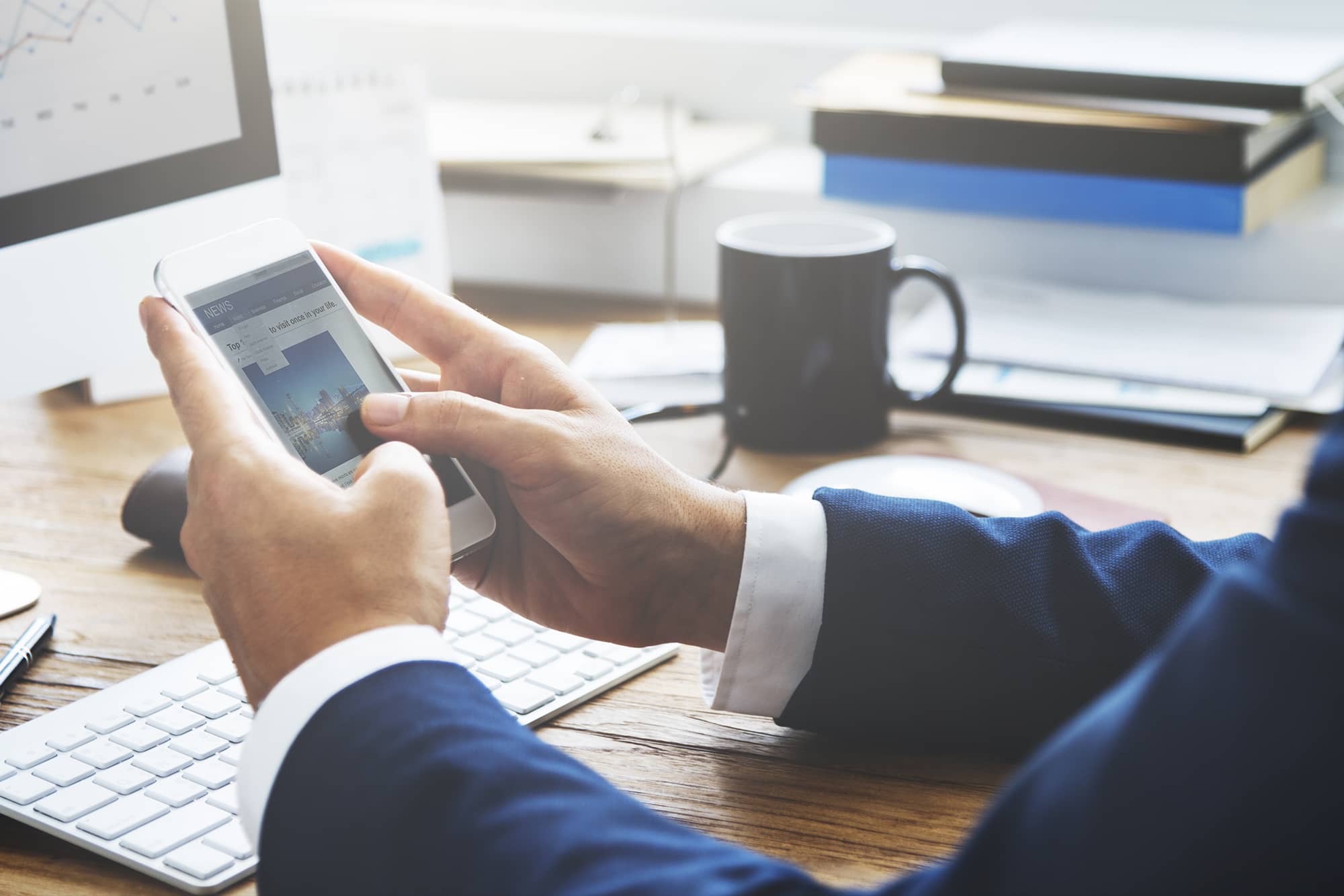 business broker reading ibbainsights spring 2021 on phone