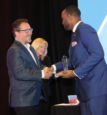 business broker accepting his award