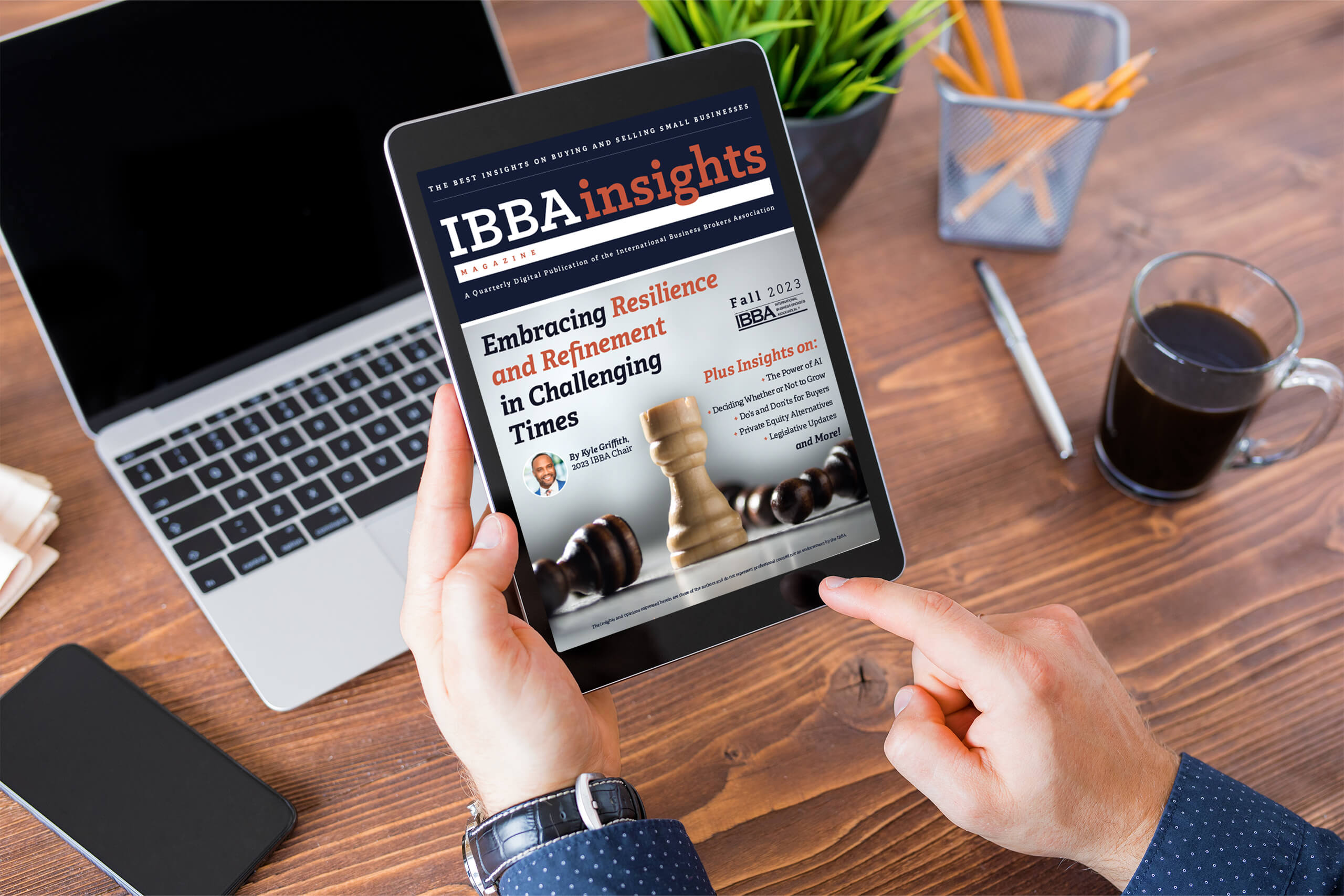 man using ipad to view ibbainsights fall 2023 magazine