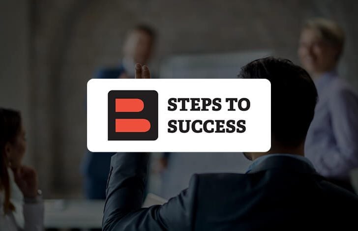 back of business broker raising hand to ask a question