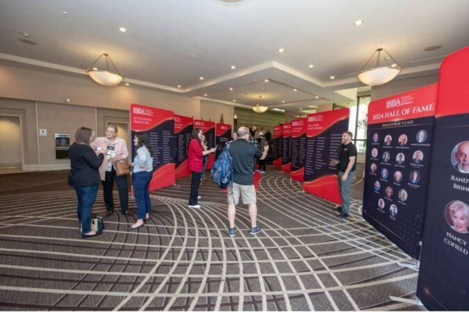 conference attendees view the award winner banners during the 2025 conference