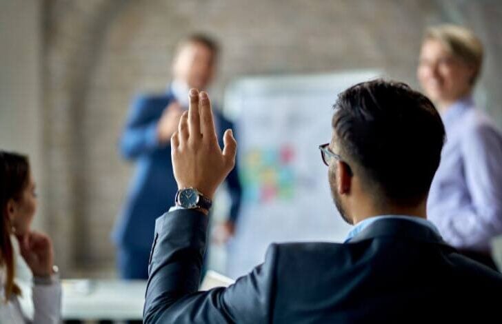 business broker raising hand