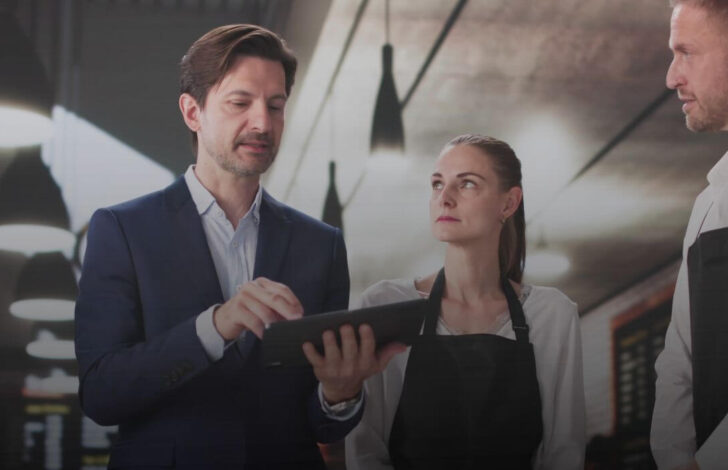 A group of restaurant workers discussing business