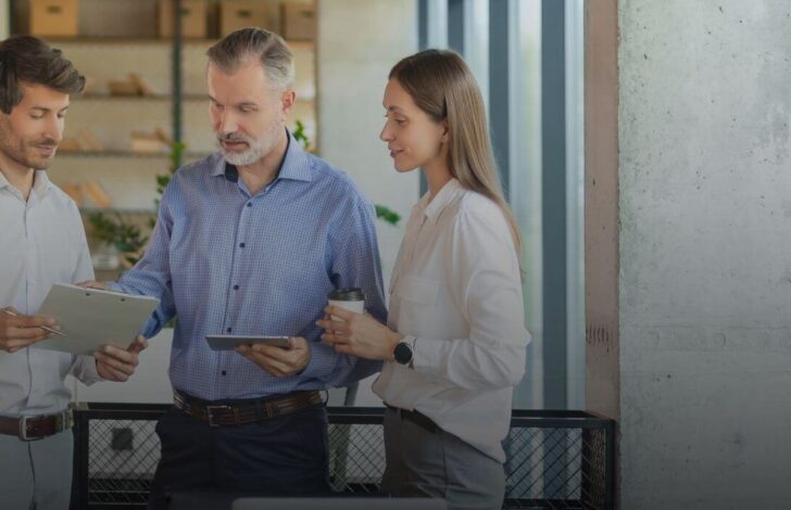 Three people discussing business together
