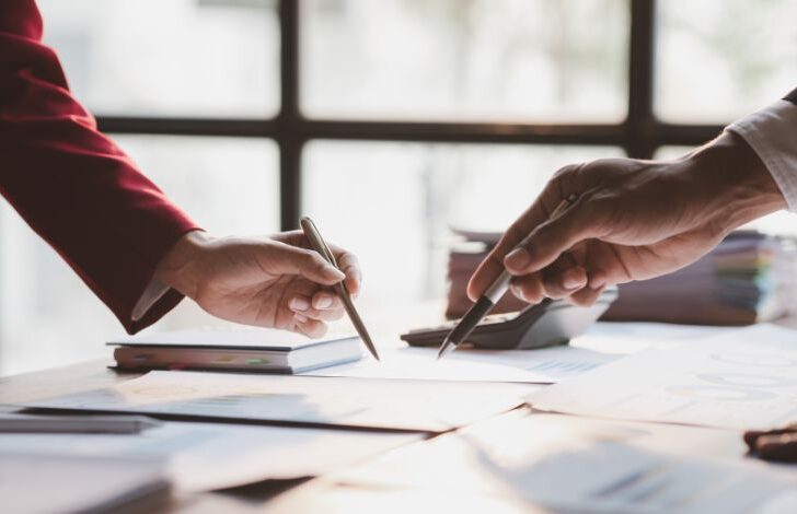 M&A advisors reviewing financial reports